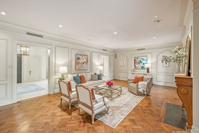 living room with ornamental molding and light parquet floors