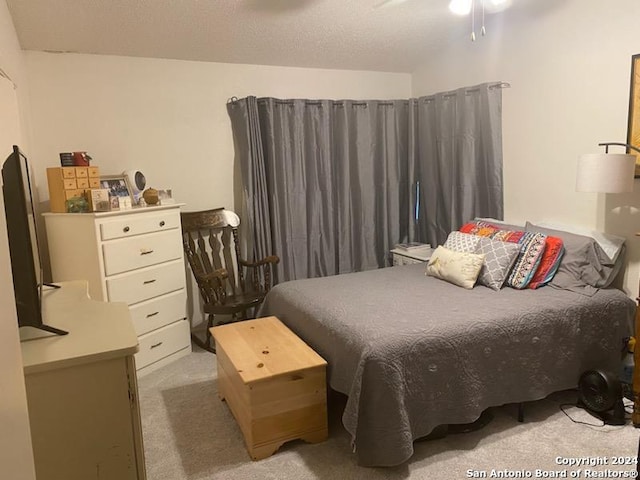 bedroom featuring ceiling fan and light carpet