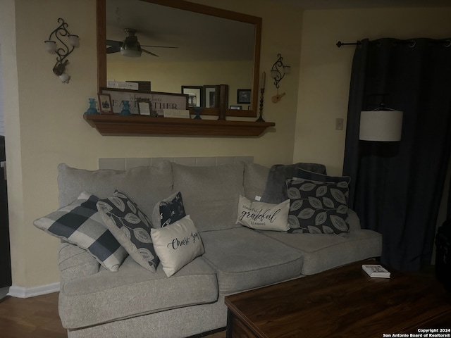 living room featuring hardwood / wood-style floors and ceiling fan