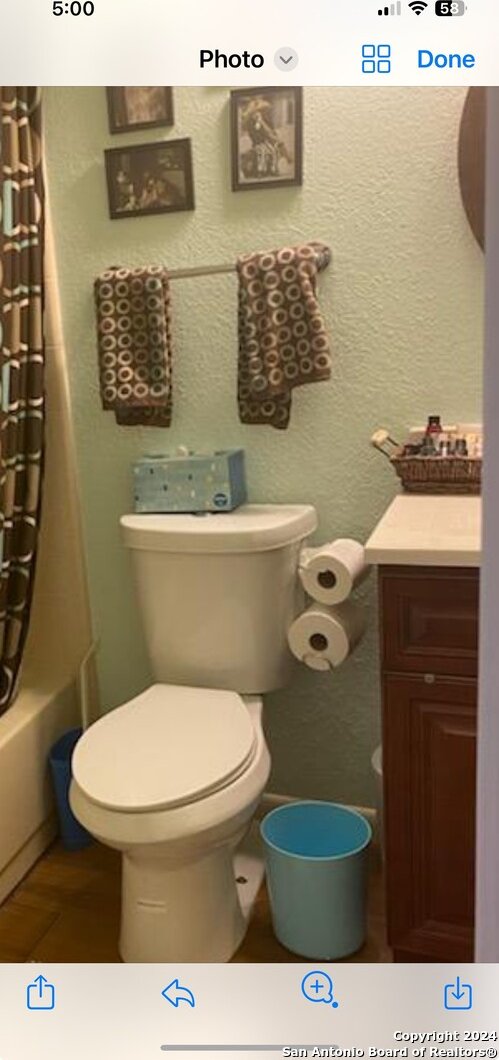 full bathroom with shower / bath combo, vanity, and toilet