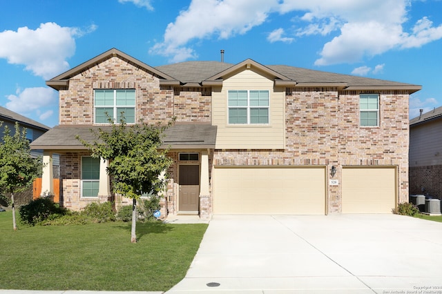 view of front of property with a garage and a front lawn