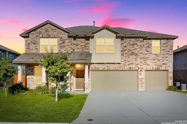 craftsman-style house with a garage and a yard