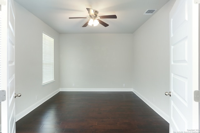 spare room featuring ceiling fan and dark hardwood / wood-style floors