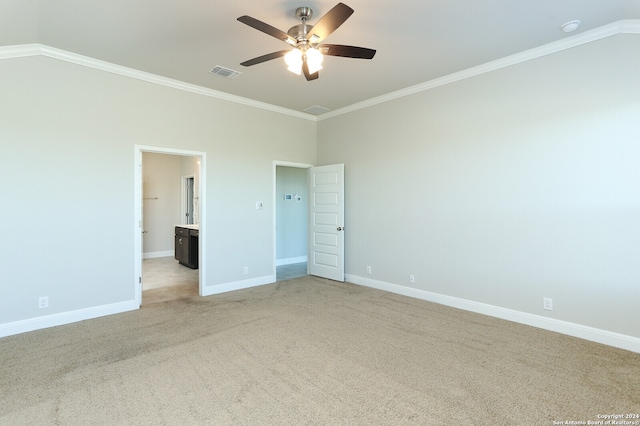 unfurnished bedroom featuring lofted ceiling, light carpet, connected bathroom, ceiling fan, and crown molding