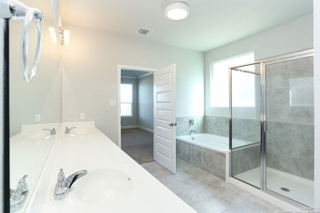 bathroom featuring plus walk in shower, vanity, and tile patterned floors