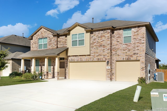 craftsman-style house featuring central AC unit, a garage, and a front lawn