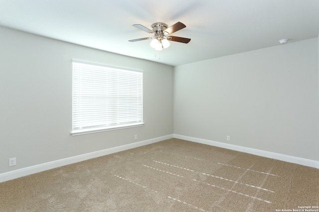 unfurnished room with ceiling fan and carpet flooring