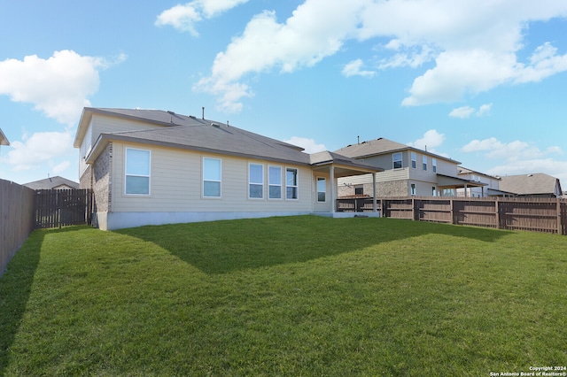 rear view of house with a lawn