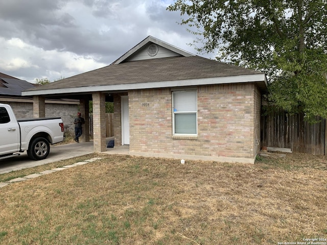 9058 Boston Hbr, San Antonio, TX 78242 - ranch-style house featuring a shingled roof, an attached garage, a front yard, brick siding, and concrete driveway