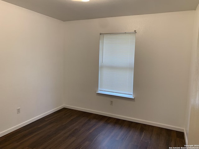 9058 Boston Hbr, San Antonio, TX 78242 - spare room featuring dark wood-style flooring and baseboards