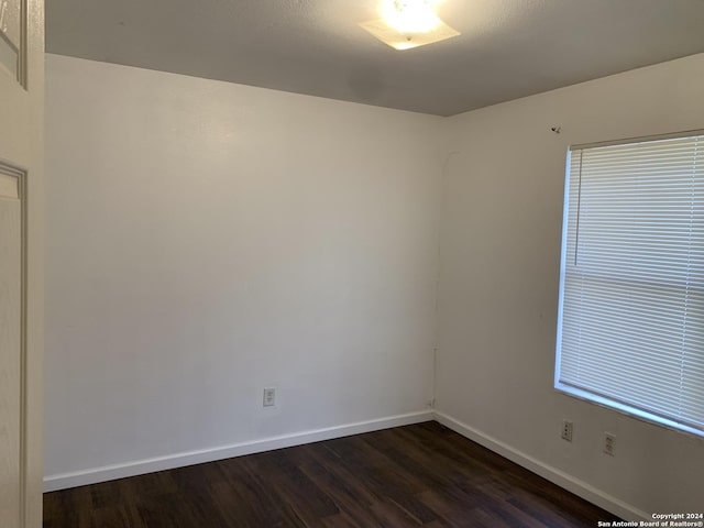 9058 Boston Hbr, San Antonio, TX 78242 - spare room featuring dark wood-type flooring and baseboards