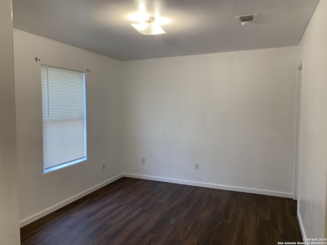 9058 Boston Hbr, San Antonio, TX 78242 - spare room with dark wood-style flooring and baseboards