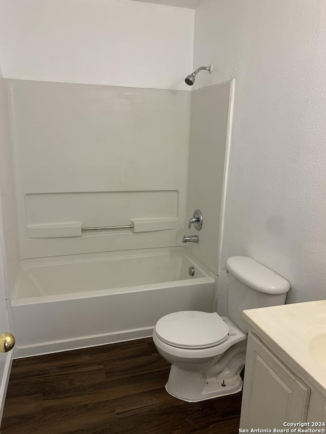 9058 Boston Hbr, San Antonio, TX 78242 - bathroom featuring wood finished floors, vanity, shower / washtub combination, and toilet