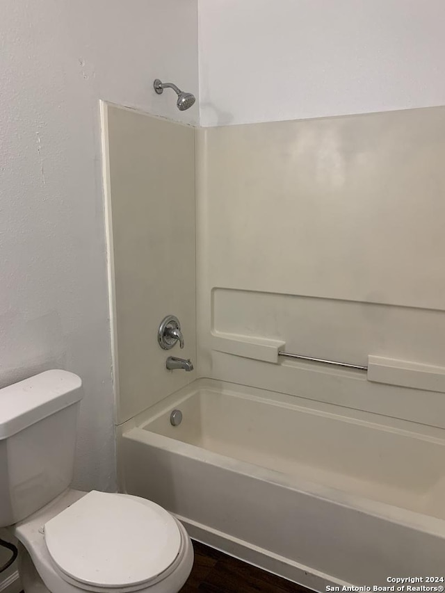 9058 Boston Hbr, San Antonio, TX 78242 - bathroom featuring toilet, wood finished floors, and tub / shower combination