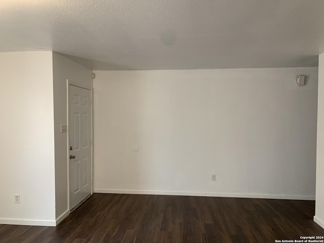 9058 Boston Hbr, San Antonio, TX 78242 - spare room with dark wood-style flooring, baseboards, and a textured ceiling