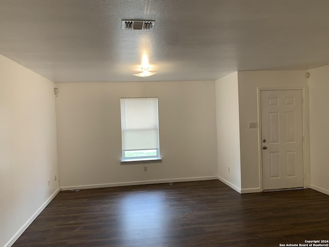 9058 Boston Hbr, San Antonio, TX 78242 - spare room featuring dark wood-type flooring and baseboards