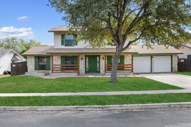 view of front of house featuring covered porch, a front lawn, and a garage