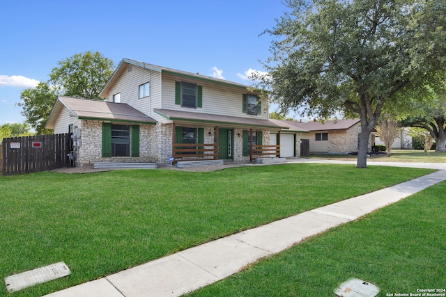 view of front of property with covered porch, a front lawn, and a garage