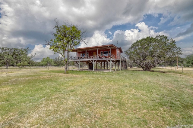 view of yard with a deck and a rural view