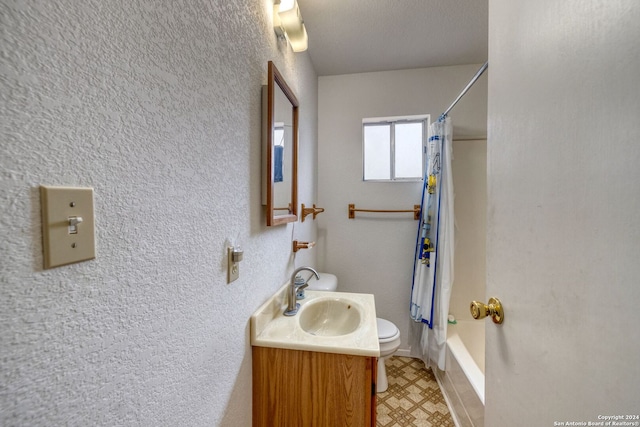 full bathroom with vanity, shower / bath combo with shower curtain, and toilet