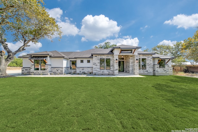 rear view of house featuring a gazebo, a lawn, and a patio area