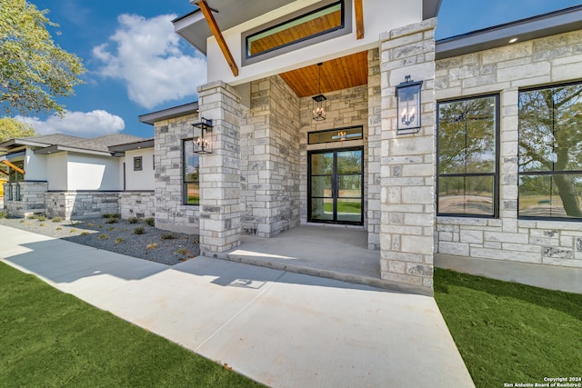 entrance to property with a lawn