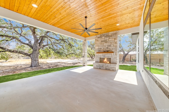 view of patio featuring ceiling fan and an outdoor stone fireplace