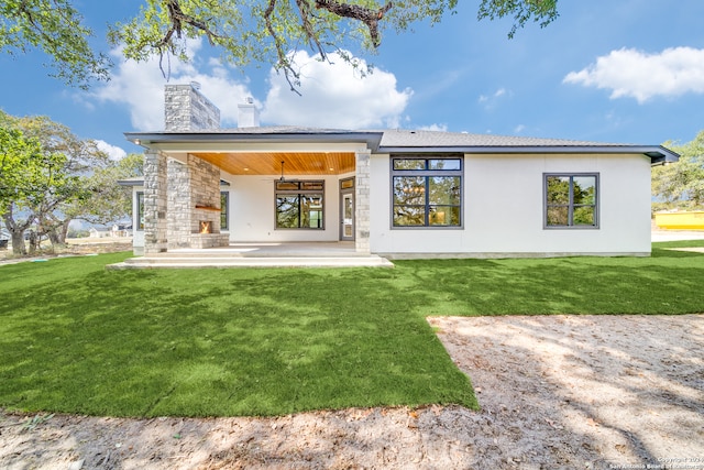 back of house with a patio area, a yard, and ceiling fan