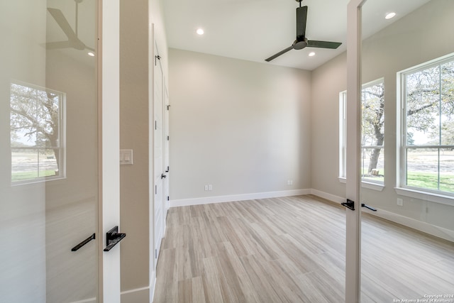 unfurnished room featuring light wood-type flooring, a healthy amount of sunlight, and ceiling fan