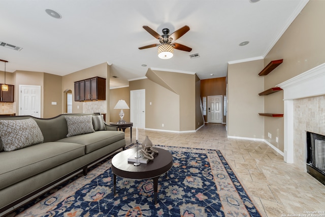 living room with ornamental molding, a fireplace, and ceiling fan