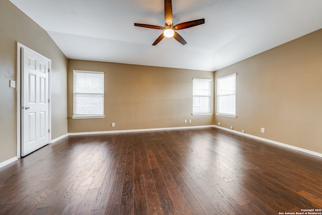 unfurnished room with lofted ceiling, ceiling fan, and dark hardwood / wood-style flooring