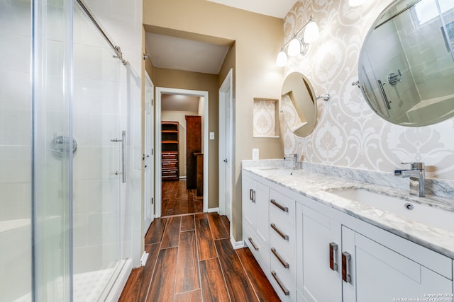 bathroom with vanity, an enclosed shower, and wood-type flooring