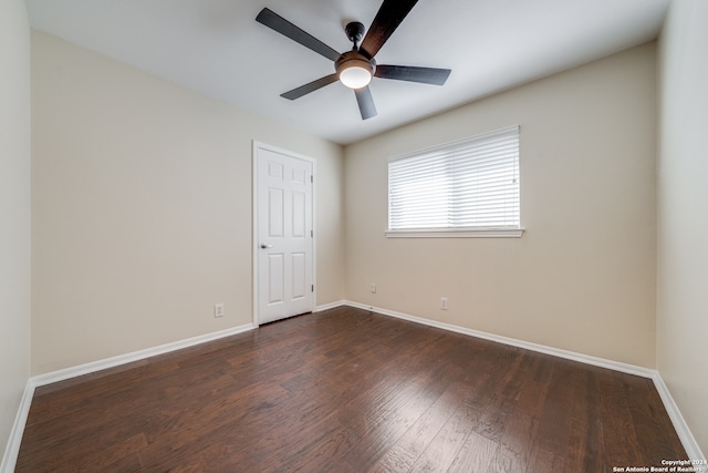 spare room with dark hardwood / wood-style floors and ceiling fan