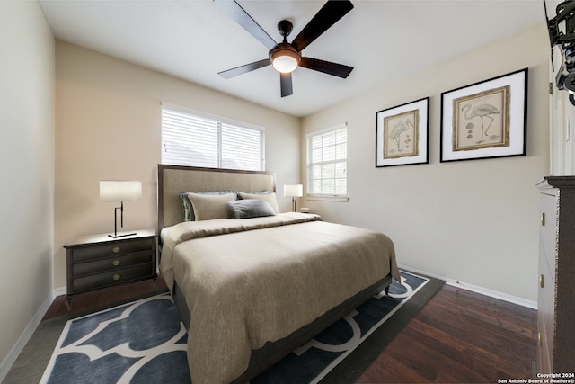 bedroom with ceiling fan and dark hardwood / wood-style flooring