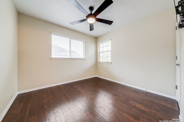 spare room featuring dark wood-type flooring and ceiling fan