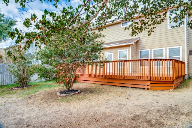 back of house featuring a wooden deck