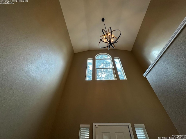 interior space with lofted ceiling and a notable chandelier