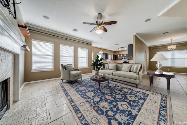 tiled living room featuring ornamental molding and ceiling fan with notable chandelier