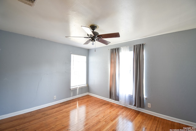 empty room with light hardwood / wood-style floors and ceiling fan