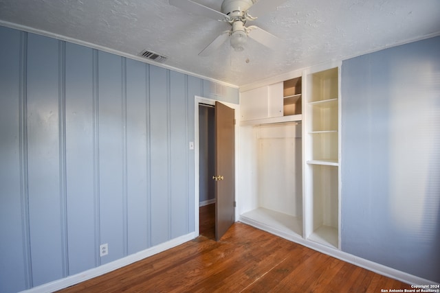 unfurnished bedroom featuring a closet, dark hardwood / wood-style floors, and ceiling fan