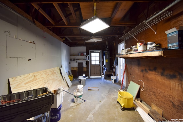 miscellaneous room featuring water heater and concrete floors