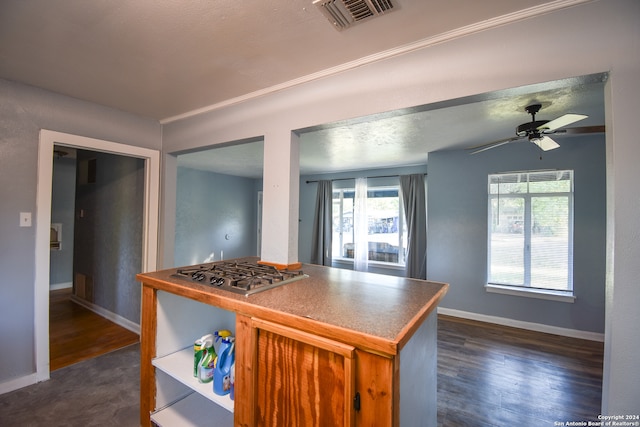 kitchen featuring dark wood-type flooring, ceiling fan, and stainless steel gas stovetop