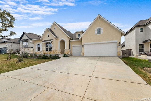 view of front of property with a front yard and a garage