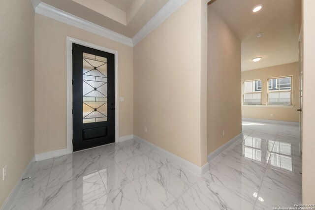 foyer featuring ornamental molding