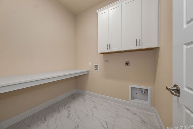 laundry room featuring cabinets, hookup for a gas dryer, washer hookup, and electric dryer hookup