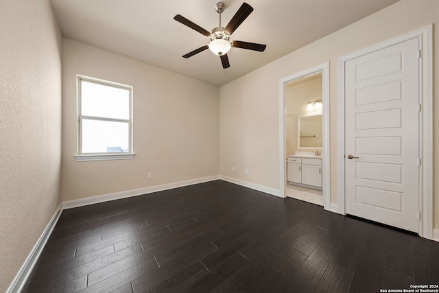 unfurnished room featuring dark wood-type flooring and ceiling fan