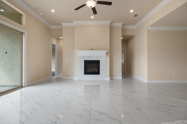 unfurnished living room featuring crown molding, a tile fireplace, and ceiling fan