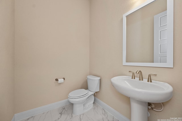 bathroom featuring sink and toilet