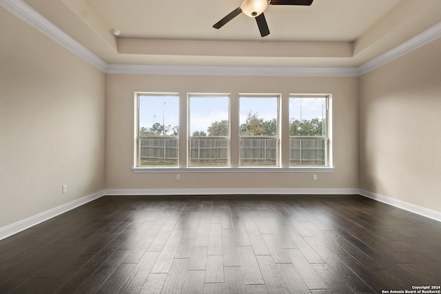 spare room with crown molding, plenty of natural light, and dark hardwood / wood-style floors