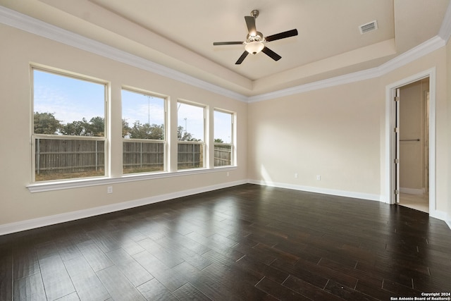 spare room with dark hardwood / wood-style flooring, ornamental molding, ceiling fan, and plenty of natural light